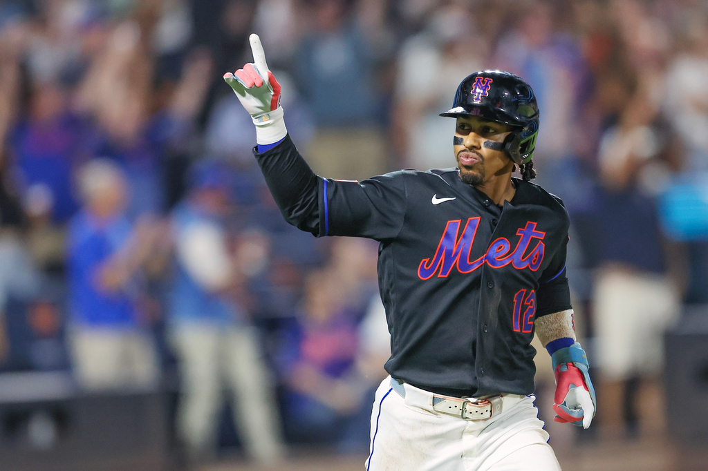 New York Mets' Francisco Lindor gestures after a home run during the sixth inning of a baseball game against the Washington Nationals, Friday, Aug. 14, 2026, in New York. (AP Photo/Heather Khalifa)