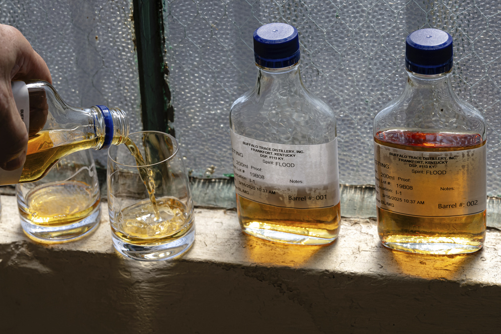 Danny Kahn, Master Distiller and Distillation/Aging Operations Director at Sazerac, Buffalo Trace's parent company, pours samples of bourbon from barrels that were exposed to floodwaters at Buffalo Trace Distillery on Sept. 16, 2025, in Frankfort, Ky. (AP Photo/Jon Cherry)