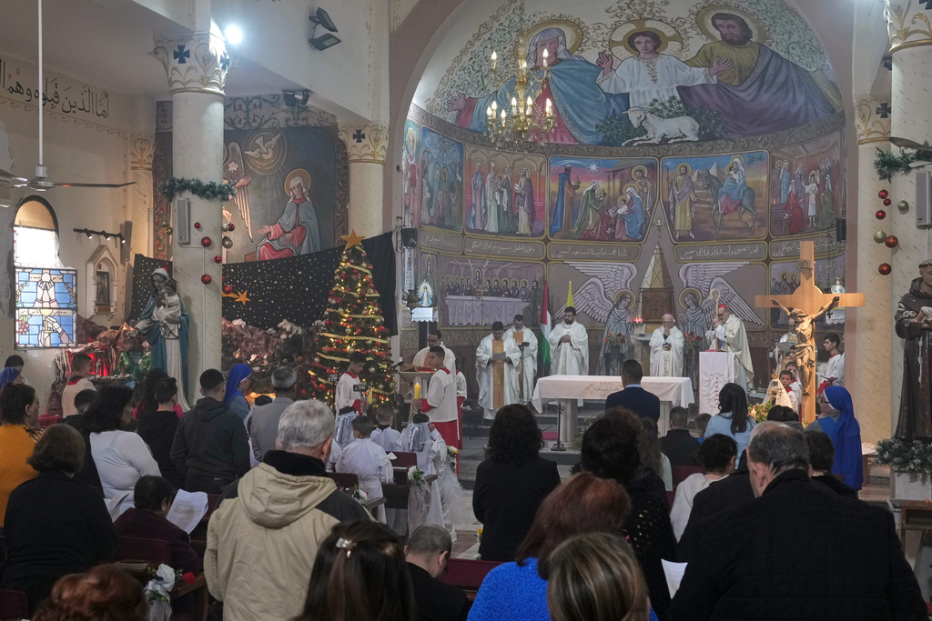 Palestinians parishioners attend a mass led by Cardinal Pierbattista Pizzaballa, the Latin Patriarch of Jerusalem, ahead of Christmas celebrations in Gaza City, Sunday, Dec. 21, 2025. (AP Photo/Jehad Alshrafi)