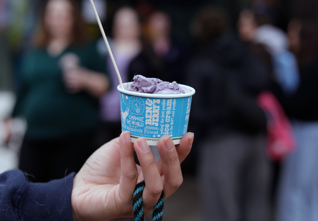 Bettina Guevara holds her free serving of ice cream outside the Ben and Jerry's scoop shop on Free Cone Day in Burlington, Vt., Tuesday, April 14, 2026. (AP Photo/Amanda Swinhart)