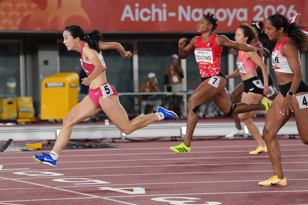 China's Chen Yujie crosses the finish line ahead of others in the women's 100-meter final at the Asian Games in Nagoya, Japan, Friday, Sept. 25, 2026. (AP Photo/Aaron Favila)