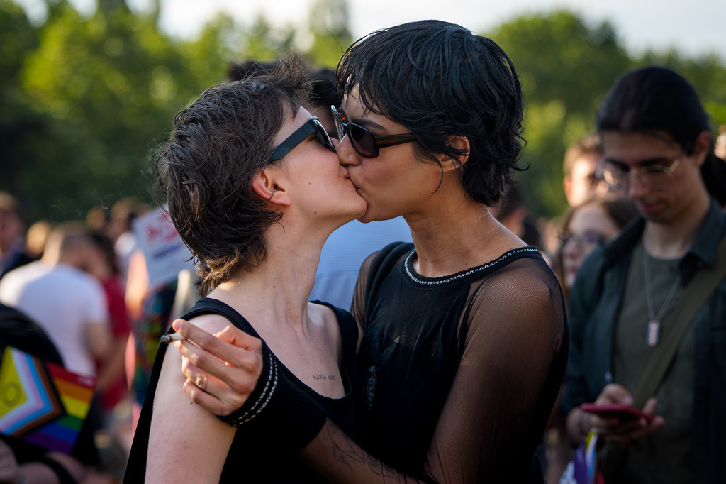Participants in the Bucharest Pride Parade kiss in Bucharest, Romania, Saturday, June 13, 2026. (AP Photo/Andreea Alexandru)