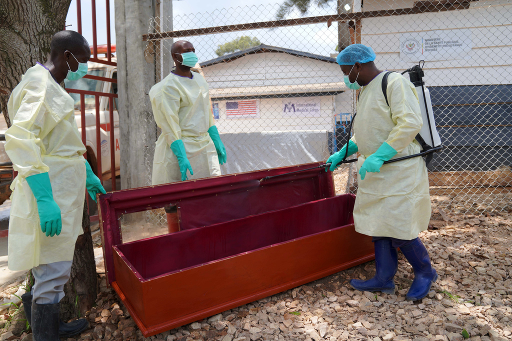 Health workers who are members of the safe and dignified burial team disinfect a coffin to bury Abineno Justine, a 38 year old woman who died of the Ebola virus, in Bunia, Congo, Friday, Sept. 4, 2026. (AP Photo/Dieudonne Dirole)