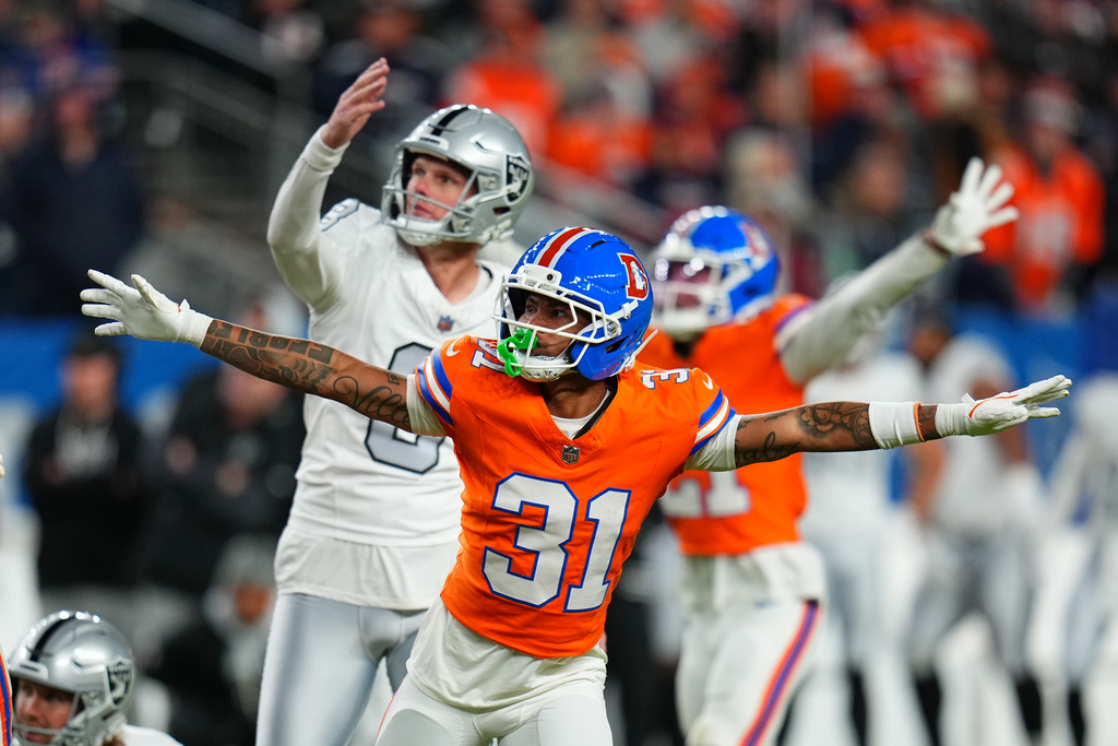 Denver Broncos' Kris Abrams-Draine (31) reacts to a missed field goal attempt by Las Vegas Raiders kicker Daniel Carlson, left, during the second half of an NFL football game Thursday, Nov. 6, 2025, in Denver. (AP Photo/Jack Dempsey)