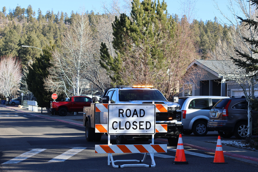 CORRECTS DATE: FILE - Law enforcement officers respond to a neighborhood in Flagstaff, Ariz., where police say a man opened fire on police on Feb. 4, 2026. (AP Photo/Cheyanne Mumphrey, File)