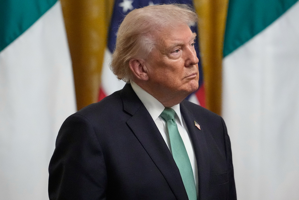 President Donald Trump listens before Ireland's Prime Minister Micheál Martin presents him with a bowl of shamrocks during a St. Patrick's Day event in the East Room of the White House, Tuesday, March 17, 2026, in Washington. (AP Photo/Julia Demaree Nikhinson)