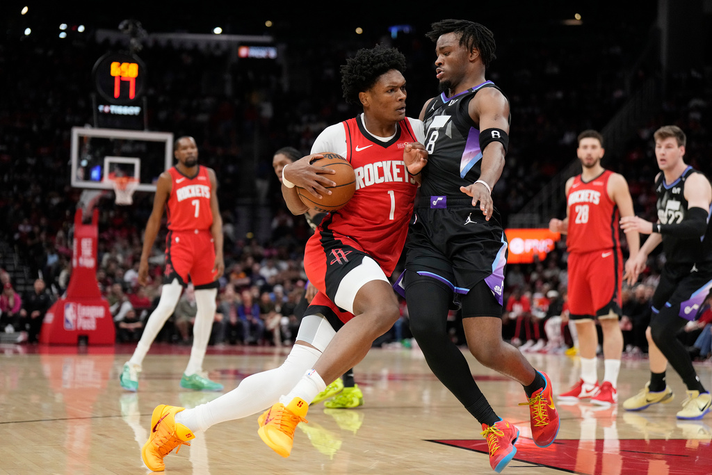 Houston Rockets guard Amen Thompson (1) controls the ball against Utah Jazz guard Isaiah Collier (8) during the first half of an NBA basketball game, Monday, Feb. 23, 2026, in Houston. (AP Photo/Karen Warren)