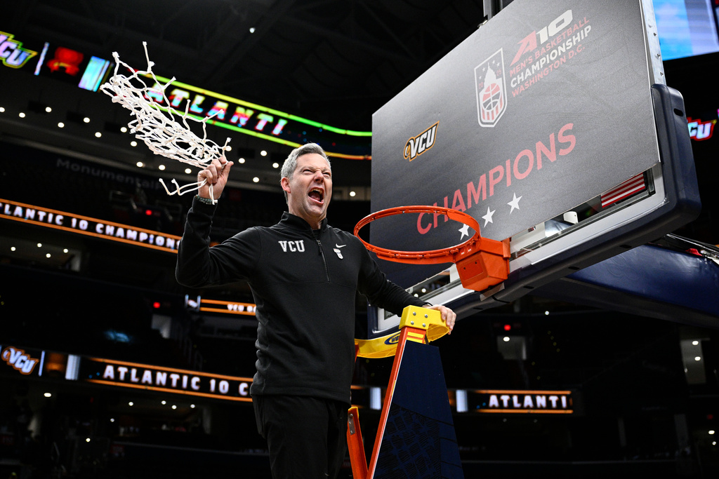 FILE - Virginia Commonwealth head coach Ryan Odom swings the net after cutting it down after winning an NCAA college basketball game in the championship of the Atlantic 10 tournament against George Mason, Sunday, March 16, 2025, in Washington. (AP Photo/Nick Wass, File)