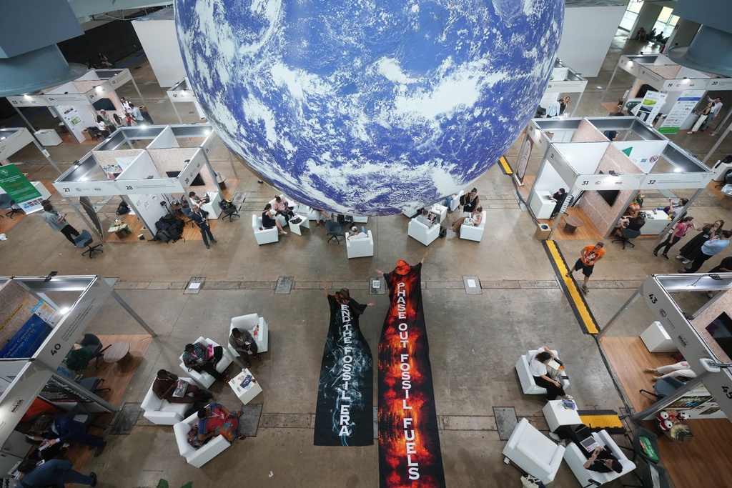 Activists participate in a demonstration to end the use of fossil fuels at the COP30 U.N. Climate Summit, Thursday, Nov. 20, 2025, in Belem, Brazil. (AP Photo/Andre Penner)