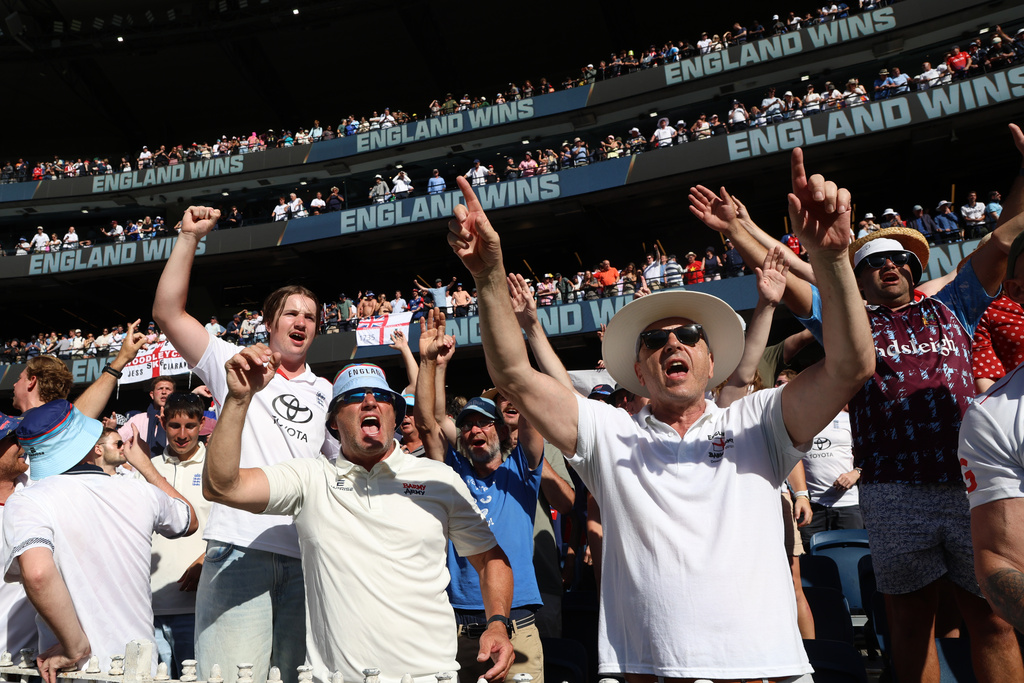 Fans celebrate England's win over Australia on Day 2 of their Ashes cricket test match in Melbourne, Saturday, Dec. 27, 2025. (AP Photo/Hamish Blair)