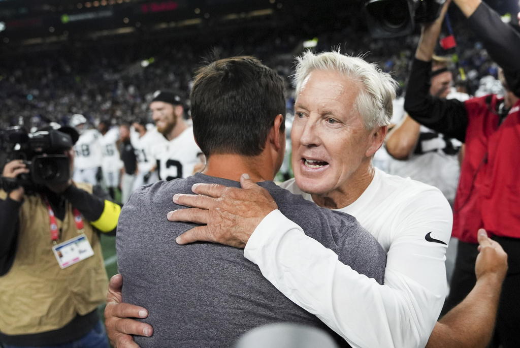 Las Vegas Raiders head coach Pete Carroll hugs Seattle Seahawks head coach Mike Macdonald after an NFL preseason football game Thursday, Aug. 7, 2025, in Seattle. (AP Photo/Lindsey Wasson)