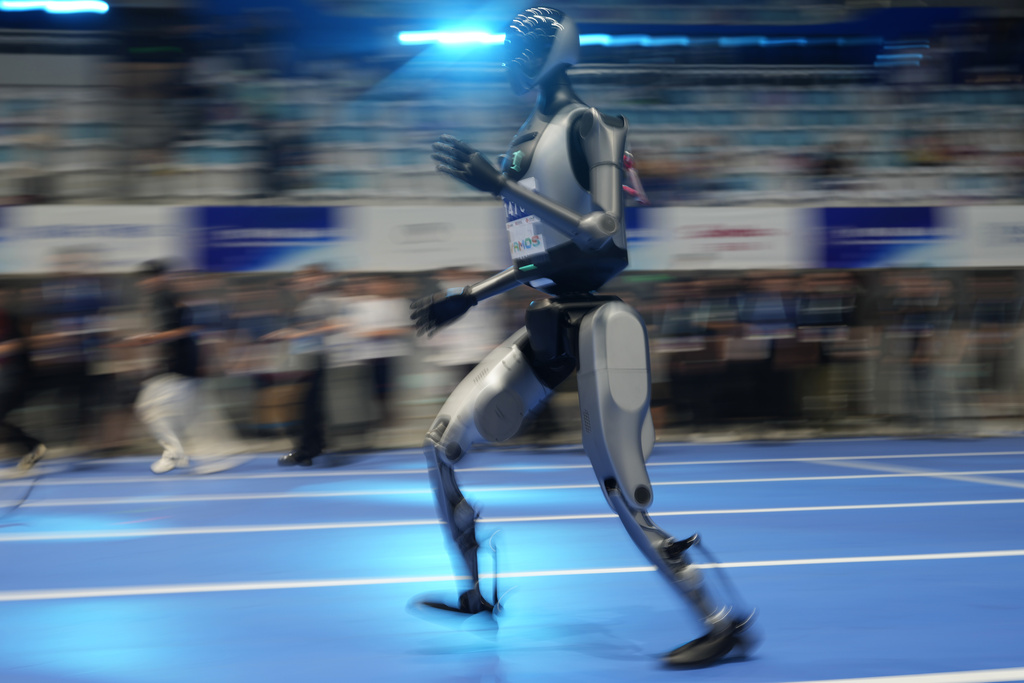A robot rehearses the 100m race before the opening ceremony of The World Humanoid Robot Games held in Beijing, China, Thursday, Aug. 14, 2025. (AP Photo/Ng Han Guan)