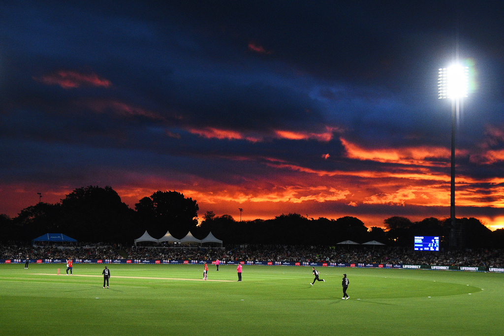 The sun sets at Hagley Oval as England bats during the T20 cricket international between New Zealand and England in Christchurch, New Zealand, Saturday, Oct.18, 2025. (Chris Symes/Photosport via AP)