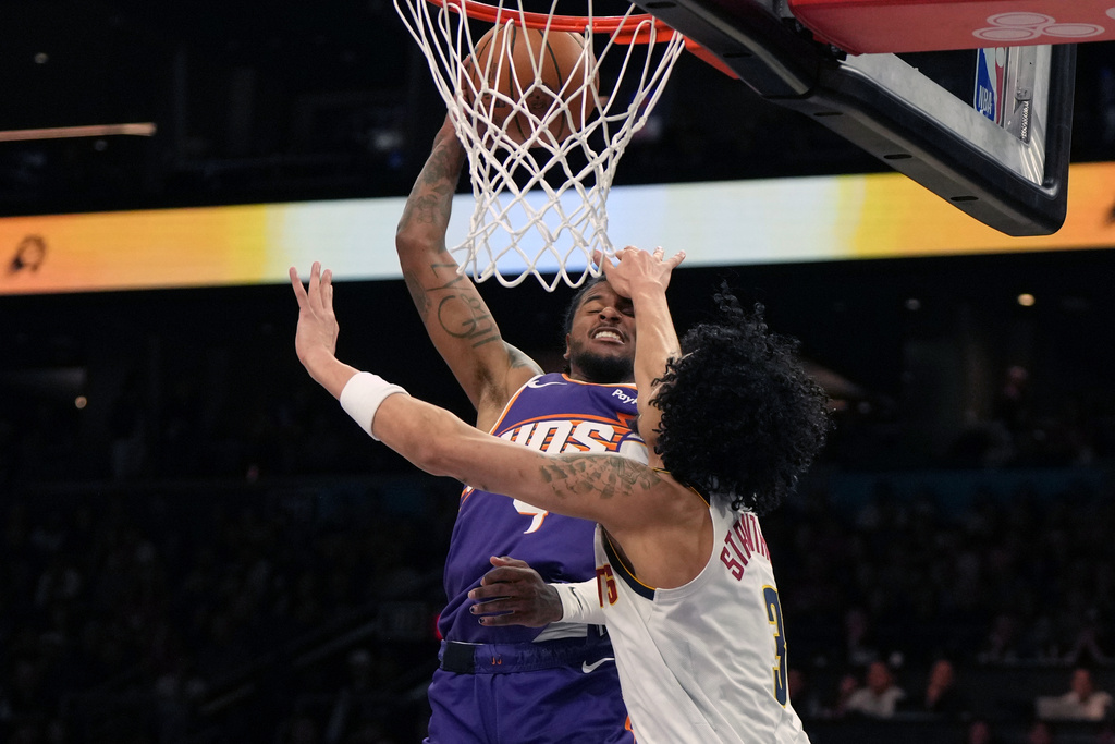 Denver Nuggets guard Julian Strawther (3) fouls Phoenix Suns guard Jalen Green during the first half of an NBA basketball game, Tuesday, March 24, 2026, in Phoenix. (AP Photo/Rick Scuteri)