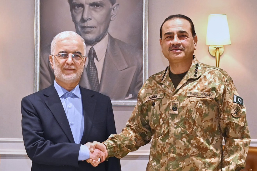 In this photo released by the Inter Services Public Relations, Iran's Interior Minister Eskandar Momeni, left, shakes hand with Pakistan's Army Chief Field Marshal Asim Munir prior to their meeting in Rawalpindi, Pakistan, Tuesday, July 21, 2026. (Inter Services Public Relations via AP)