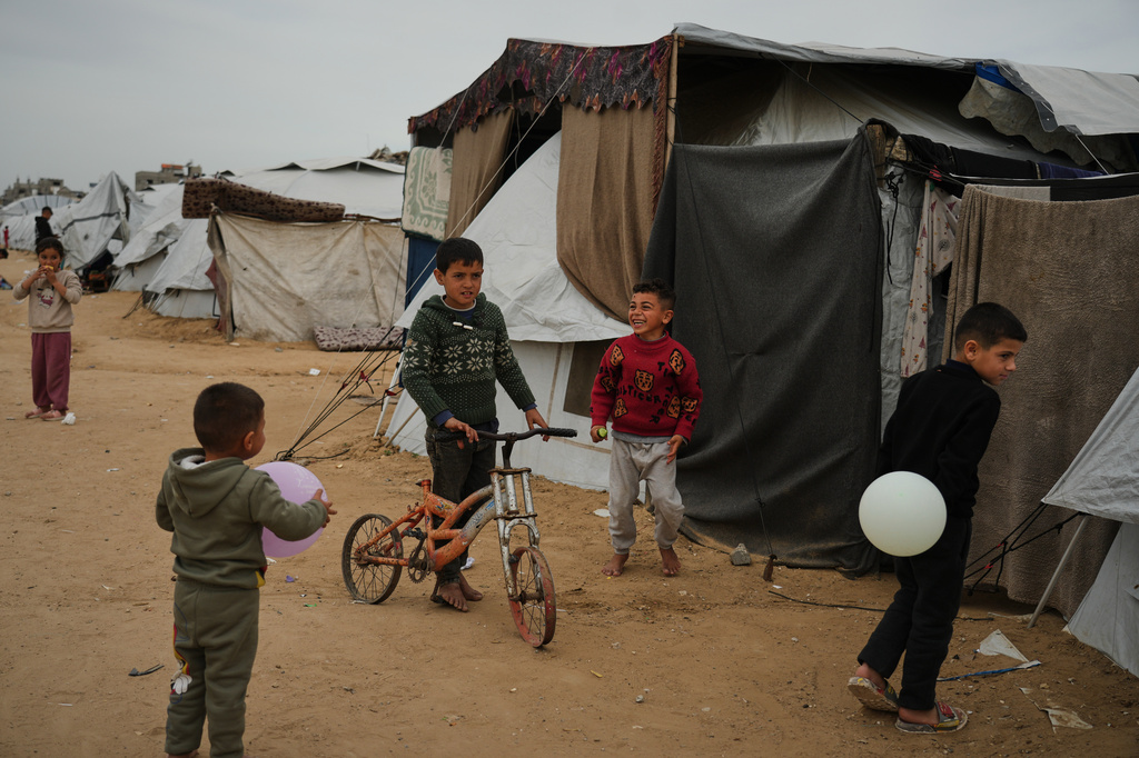 Palestinian children play at an orphanage camp in Khan Younis, southern Gaza Strip, Thursday, Feb.12, 2026. (AP Photo/Jehad Alshrafi)