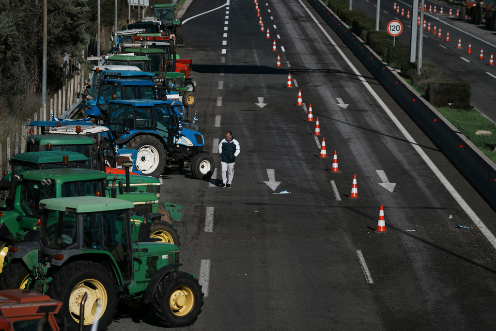 Tractors block a highway as farmers protest in Kastro, about 130 kilometers (81 miles) north of Athens, Greece, over delays in the payment of European Union-backed agricultural subsidies, on Thursday, Jan. 8 2025. (AP Photo/Thanassis Stavrakis)