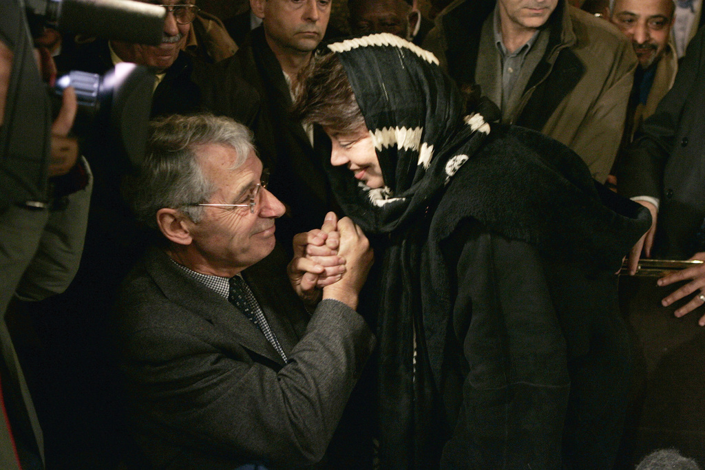 FILE - Benoit Aubenas, left, the father of French journalist Florence Aubenas, who has been missing in Iraq since Jan. 5, 2005, is comforted by Palestinian envoy to France, Leila Shahid, during a gathering ceremony as part the Eid Al Adha at the Paris Mosque on Jan. 20, 2005. (AP Photo/Francois Mori, File)