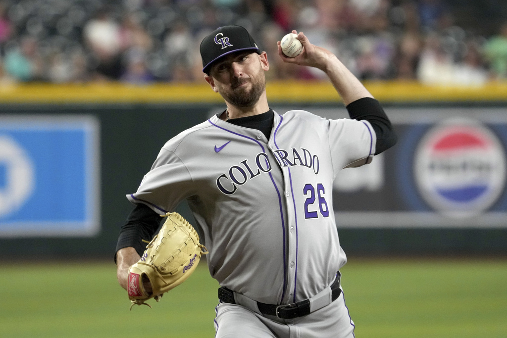 Colorado Rockies pitcher Austin Gomber throws against the Arizona Diamondbacks in the first inning of a baseball game, Friday, Aug. 8, 2025, in Phoenix. (AP Photo/Rick Scuteri)