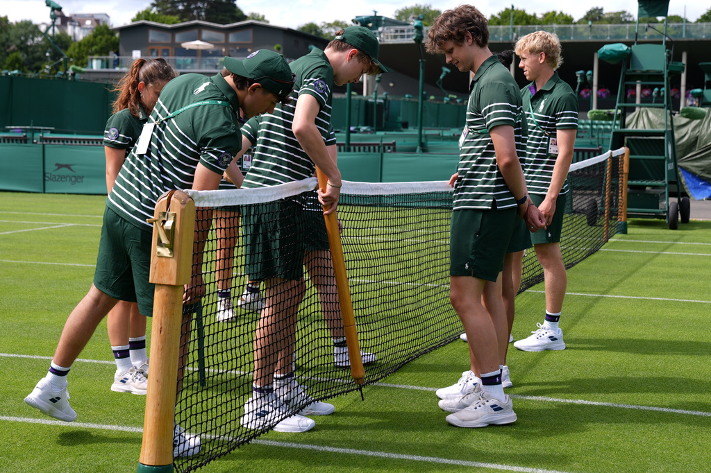 Ground staff fixes the net of a court one day ahead of the start of the Wimbledon Tennis Championships in London, Sunday, June 28, 2026.(AP Photo/Maja Smiejkowska)