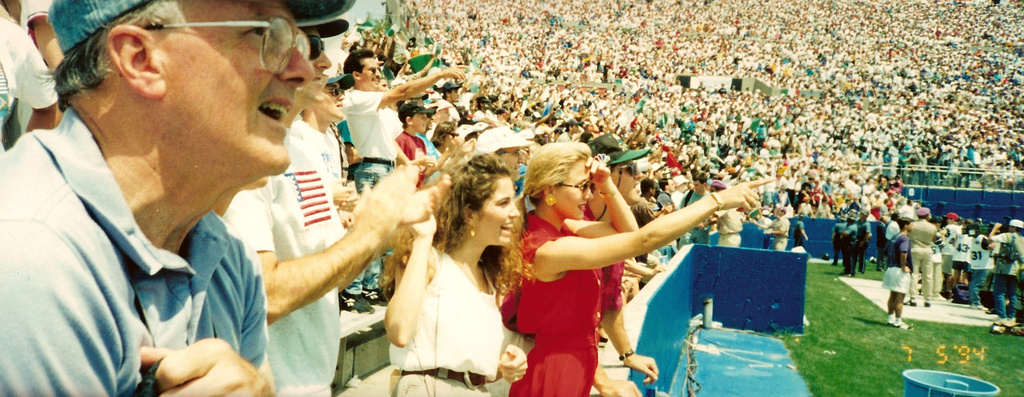 In this photo provided by the Hunt family, Lamar Hunt, left, watches a World Cup match between Italy and Nigeria on July 5, 1994, in Foxborough, Mass. (Hunt Family via AP)