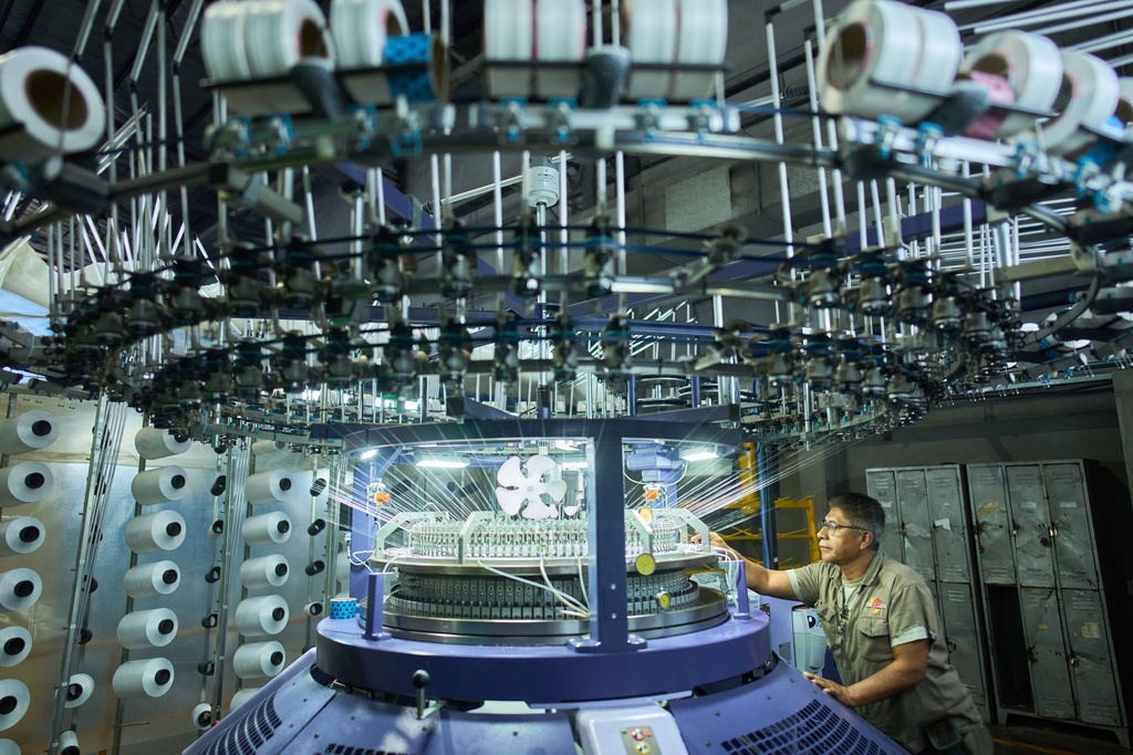 Marco Correa works at the Galfione Group textile factory in Buenos Aires, Argentina, Monday, Oct. 13, 2025. (AP Photo/Rodrigo Abd)