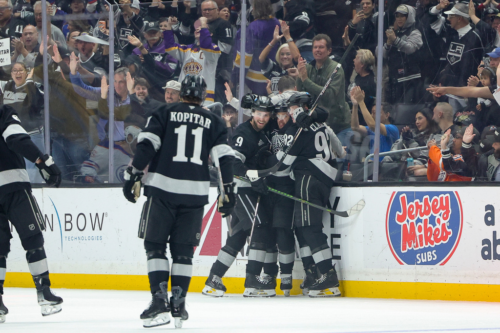Los Angeles Kings left wing Artemi Panarin, second from right, celebrates with center Anze Kopitar (11), right wing Adrian Kempe (9), and defenseman Brandt Clarke (92) after scoring during the first period of an NHL hockey game against the Edmonton Oilers, Saturday, April 11, 2026, in Los Angeles. (AP Photo/Ryan Sun)