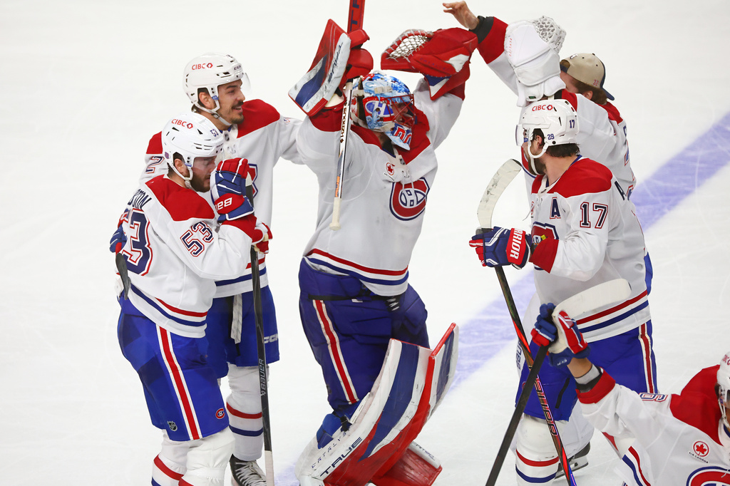 Montreal Canadiens players celebrate victory following the overtime period in Game 7 of a second-round NHL hockey Stanley Cup playoff series against the Buffalo Sabres, Monday, May 18, 2026, in Buffalo, N.Y. (AP Photo/Jeffrey T. Barnes)
