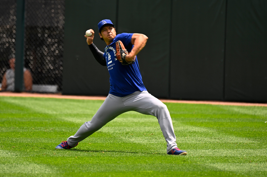 Los Angeles Dodgers two-way player Shohei Ohtani, from Japan, warms up before a baseball game against the Chicago White Sox, Saturday, June 13, 2026, in Chicago. (AP Photo/Matt Marton)