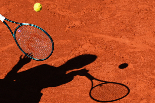 FILE - A player casts a shadow upon the court as they play a shot during the French Tennis Open, Friday, May 30, 2025, at the Roland-Garros stadium in Paris. (AP Photo/Lindsey Wasson, File) FILE - A player casts a shadow upon the court as they play a shot during the French Tennis Open, Friday, May 30, 2025, at the Roland-Garros stadium in Paris. (AP Photo/Lindsey Wasson, File)