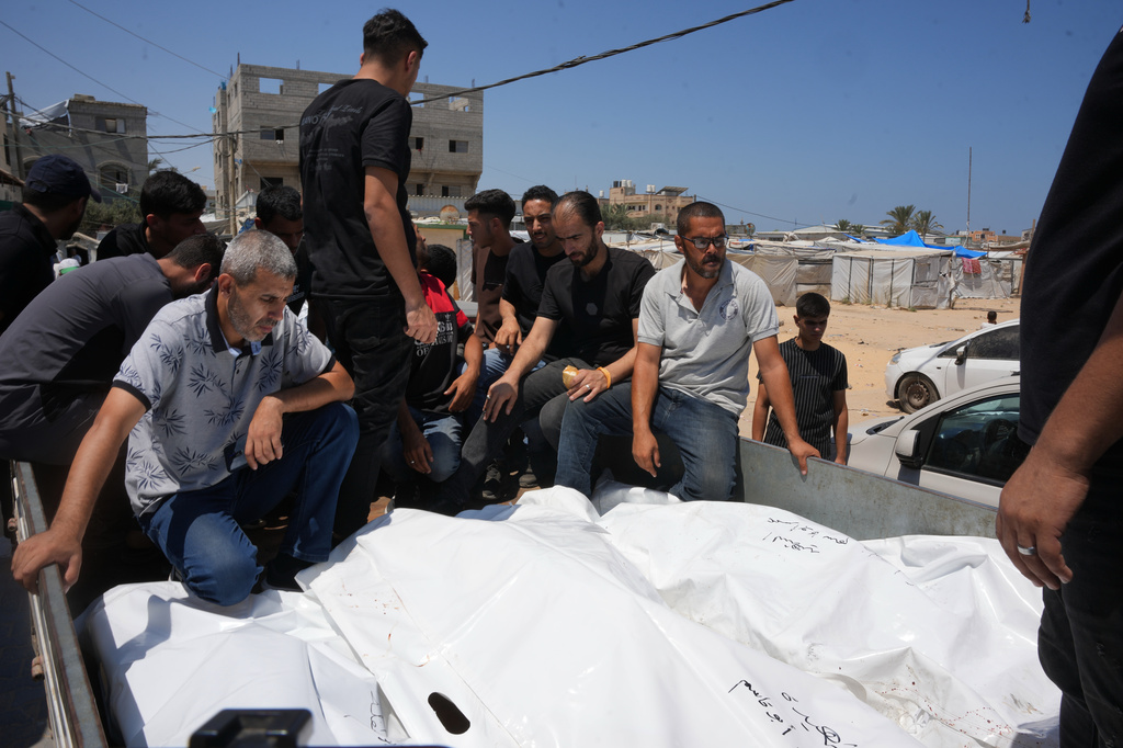 Palestinians carry the bodies of people killed in an Israeli military strike on a residential building on the back of a vehicle as they attend their funeral at Al-Aqsa Hospital in Deir al-Balah, central Gaza Strip, Wednesday, July 15, 2026.(AP Photo/Abdel Kareem Hana)