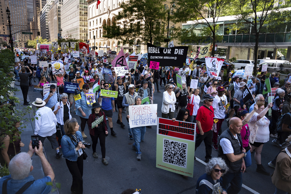 People march through Manhattan at the "Make Billionaires Pay" climate protest, Saturday, Sept. 20, 2025, in New York. (AP Photo/Angelina Katsanis)