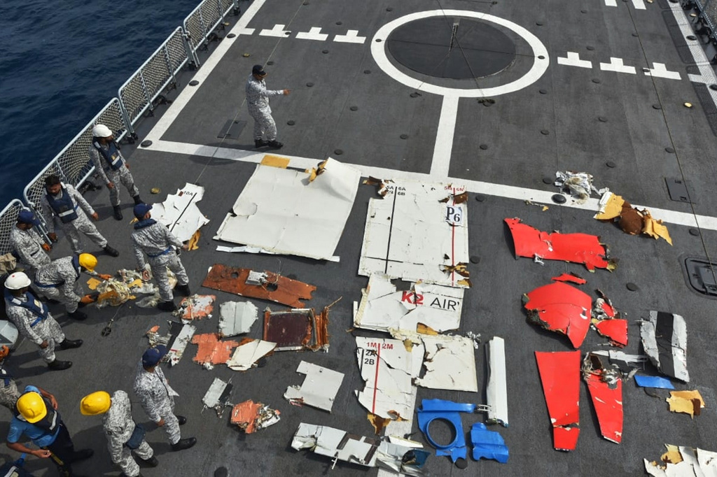 In this photo released by Pakistan Navy, Pakistan Navy personnel examine the wreckage of a cargo plane of the private carrier K2 Airways on a naval ship after recovering them from deep sea near Omara, a town some 360 kms. (220 miles) west of Karachi, Pakistan, Wednesday, July 8, 2026. (Pakistan Navy via AP)