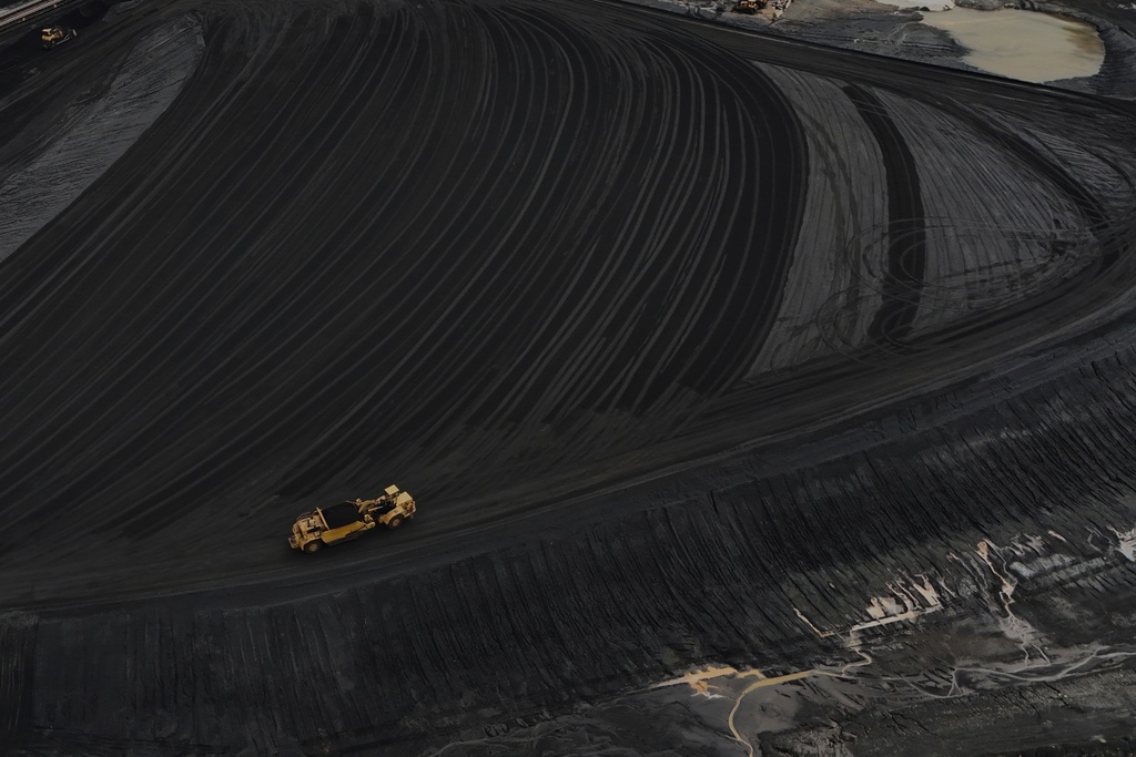FILE - Heavy equipment moves through coal at the Gen. James Gavin Power Plant, a coal-fired power plant, April 14, 2025, in Cheshire, Ohio. (AP Photo/Joshua A. Bickel, File)