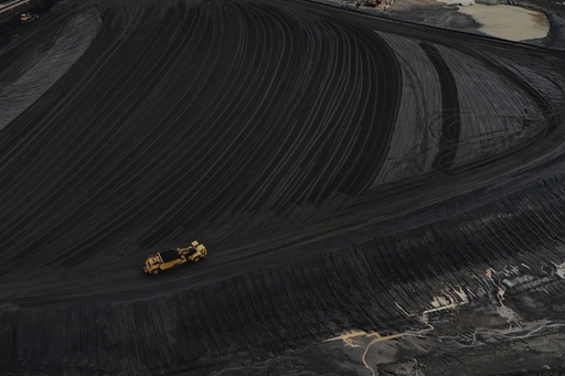 FILE - Heavy equipment moves through coal at the Gen. James Gavin Power Plant, a coal-fired power plant, April 14, 2025, in Cheshire, Ohio. (AP Photo/Joshua A. Bickel, File) FILE - Heavy equipment moves through coal at the Gen. James Gavin Power Plant, a coal-fired power plant, April 14, 2025, in Cheshire, Ohio. (AP Photo/Joshua A. Bickel, File)
