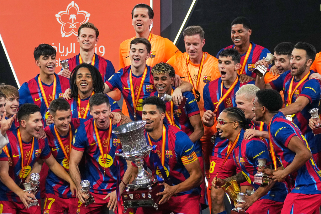 Barcelona players celebrate after winning the Spanish Super Cup final soccer match against Real Madrid at King Abdullah Sports City Stadium in Jeddah, Saudi Arabia, Sunday, Jan. 11, 2026. (AP Photo/Altaf Qadri)