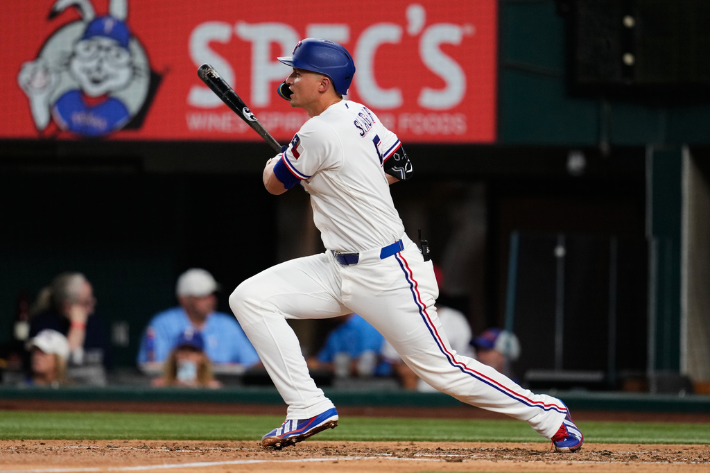 Texas Rangers' Corey Seager follows through on a double in the fifth inning of a baseball game against the Washington Nationals Thursday, Aug. 20, 2026, in Arlington, Texas. (AP Photo/Tony Gutierrez)