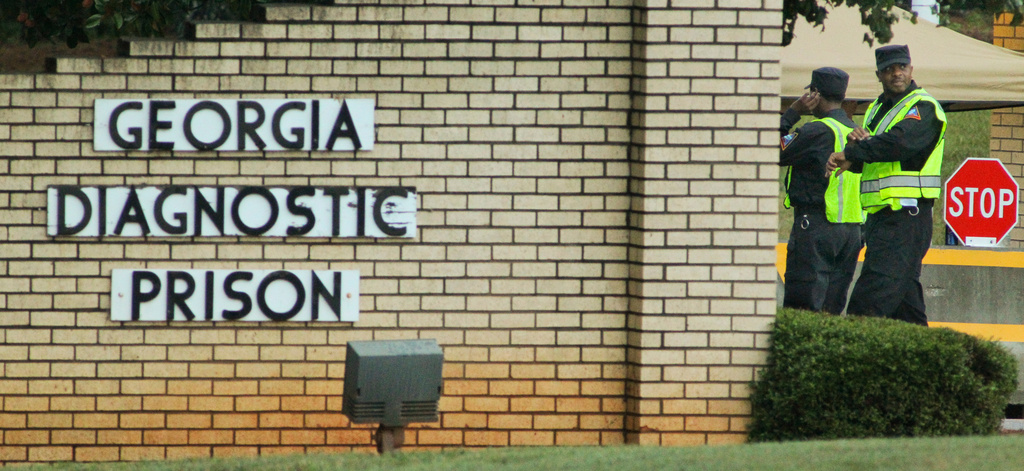 FILE - Guards stand at the front of Georgia Diagnostic Prison, Wednesday, Sept. 21, 2011, in Jackson, Ga. (John Spink/Atlanta Journal-Constitution via AP, File)