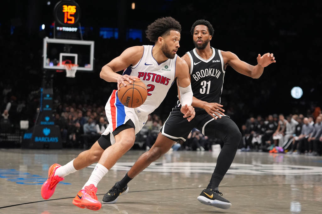Detroit Pistons' Cade Cunningham (2) drives past Brooklyn Nets' Chaney Johnson (31) during the first half of an NBA basketball game Tuesday, March 10, 2026, in New York. (AP Photo/Frank Franklin II)