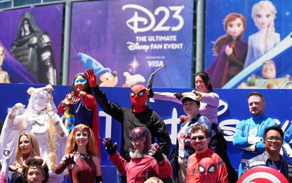 Marvel Universe cosplayers take part in a photo op outside the entrance to D23: The Ultimate Disney Fan Event on Friday, Aug. 14, 2026, at the Anaheim Convention Center in Anaheim, Calif. (AP Photo/Chris Pizzello)