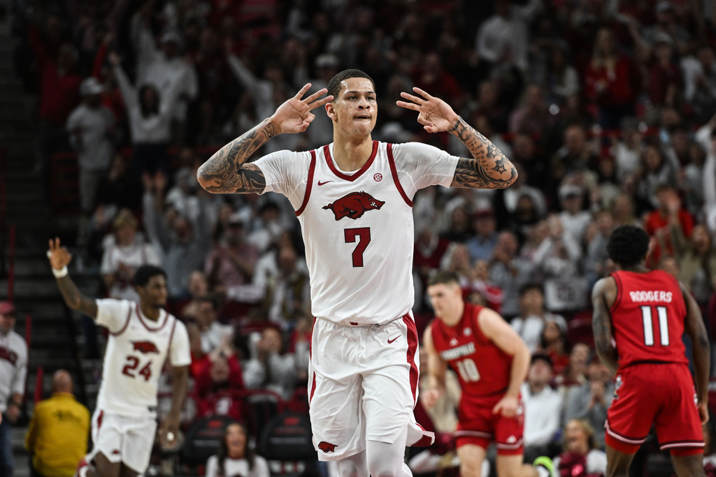 Arkansas forward Trevon Brazile (7) celebrates after hitting a three point shot against Louisville during the first half of an NCAA college basketball game Wednesday, Dec. 3, 2025, in Fayetteville, Ark. (AP Photo/Michael Woods)