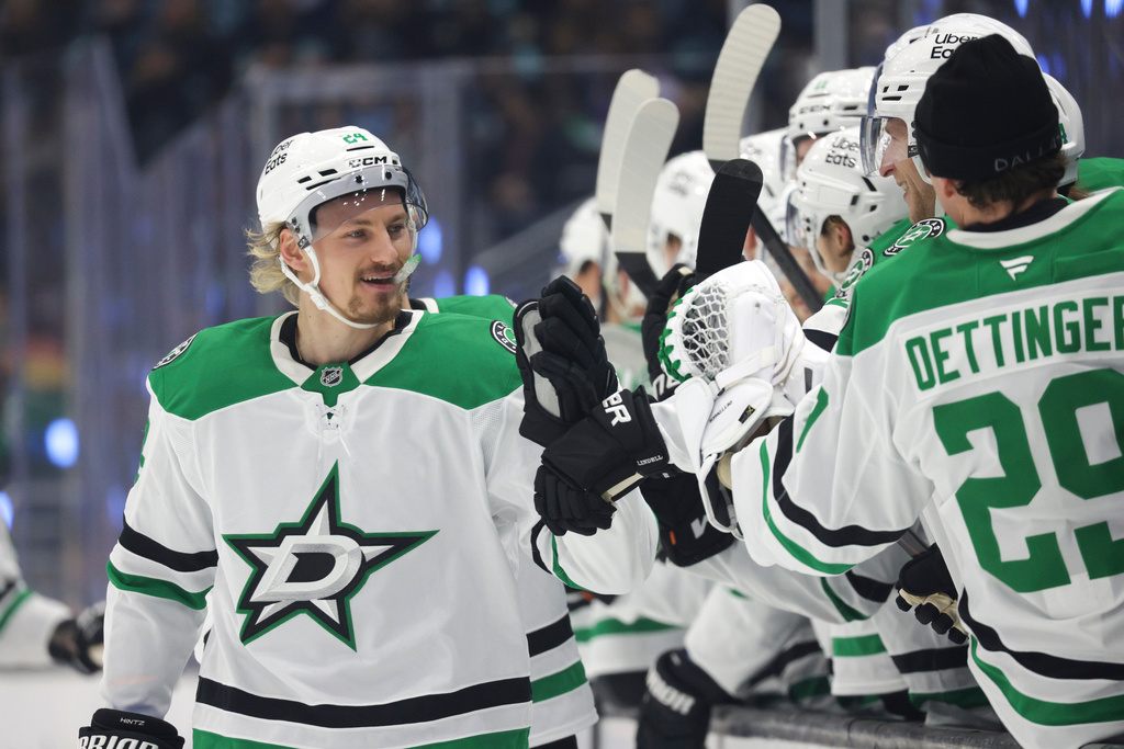 Dallas Stars center Roope Hintz (24) celebrates with the bench after scoring during the first period of an NHL hockey game against the Seattle Kraken, Wednesday, Nov. 26, 2025, in Seattle. (AP Photo/Jason Redmond)