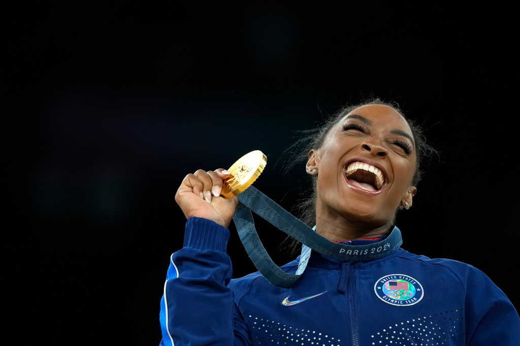 FILE - Simone Biles, of the United States, celebrates after winning the gold medal at the medal ceremony during the women's artistic gymnastics individual vault finals at Bercy Arena at the 2024 Summer Olympics, on Aug. 3, 2024, in Paris, France. (AP Photo/Francisco Seco, File)