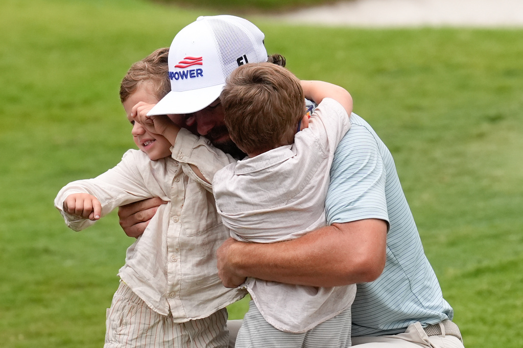 Cameron Young greets his family as he celebrates after winning the Cadillac Championship PGA golf tournament Sunday, May 3, 2026, in Doral, Fla. (AP Photo/David J. Phillip)