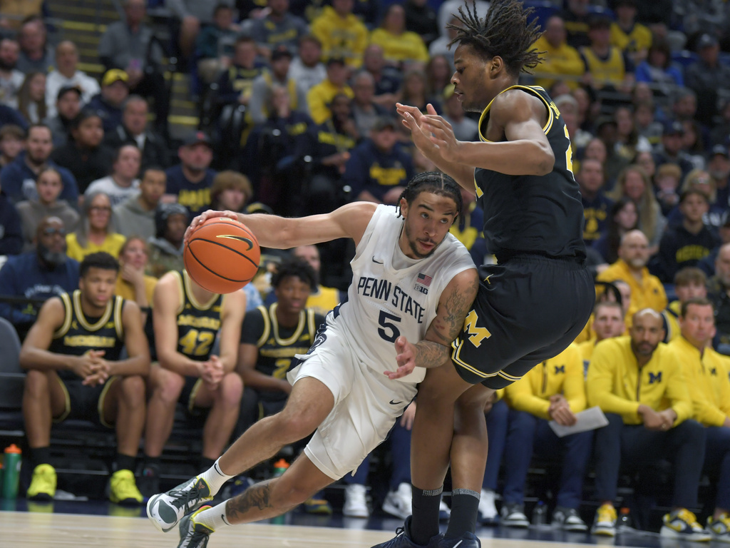 Penn State's Freddie Dilione V (5) drives the baseline on Michigan's Trey McKenney, right, during the first half of an NCAA college basketball game Tuesday, Jan. 6, 2026, in State College, Pa. (AP Photo/Gary M. Baranec)