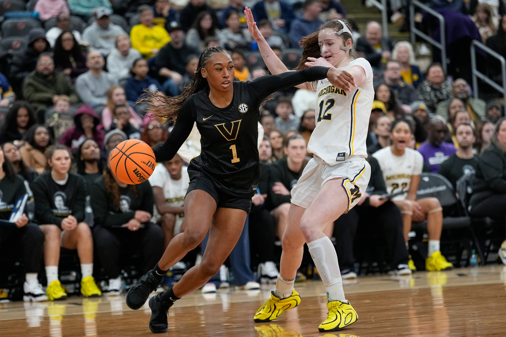 Vanderbilt's Mikayla Blakes, left, moves around Michigan's Syla Swords during the first half of an NCAA women's college basketball game in Newark, N.J., Monday, Jan. 19, 2026. (AP Photo/Seth Wenig)