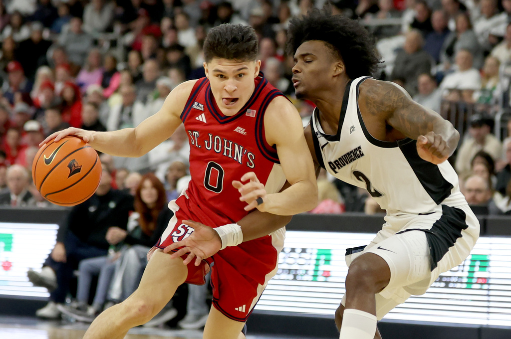 St. John's guard Dylan Darling (0) manuevers around Providence guard Jaylin Sellers (2) during the first half of an NCAA college basketball game, Saturday, Feb. 14, 2026, in Providence, R.I. (AP Photo/Mark Stockwell)