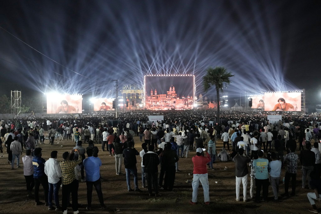 Fans of Tollywood superstar Mahesh Babu arrive to watch unveiling of first look of film "Varanasi" in Hyderabad, India, Saturday, Nov. 15, 2025. (AP Photo/Mahesh Kumar A.)