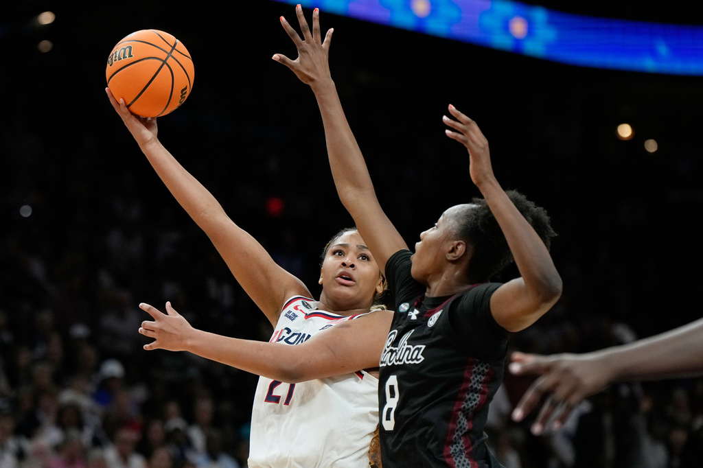 FILE - UConn forward Sarah Strong (21) shoots over South Carolina forward Joyce Edwards (8) during the second half of a woman's NCAA college basketball tournament semifinal game at the Final Four, April 3, 2026, in Phoenix. (AP Photo/Ross D. Franklin, File)