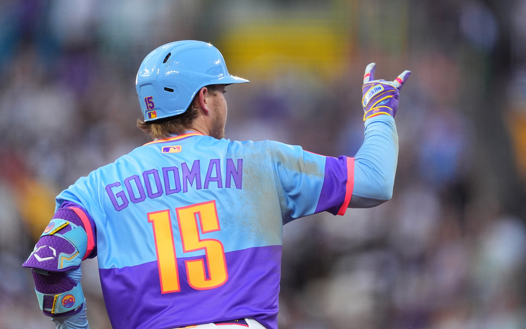 Colorado Rockies' Hunter Goodman gestures to the bullpen as he circles the bases after hitting a solo home run off Milwaukee Brewers starting pitcher Brandon Sproat in the third inning of a baseball game Friday, June 5, 2026, in Denver. (AP Photo/David Zalubowski)
